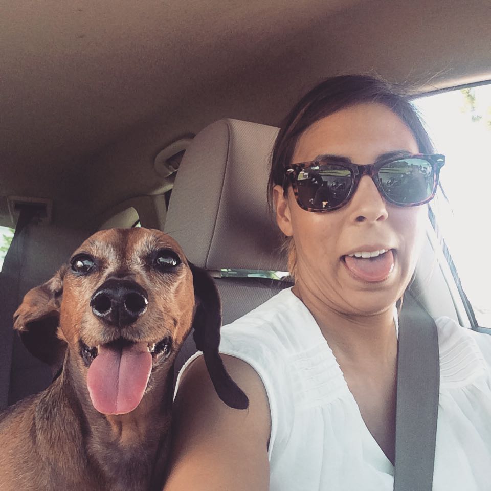Amy and her daschund in a car