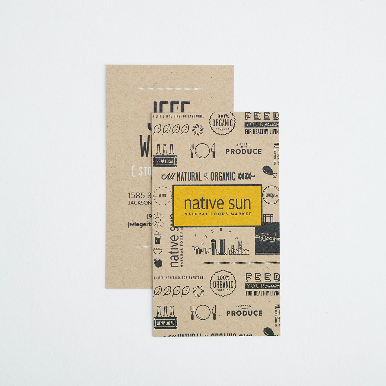 Two unique business cards printed on kraft paper stock with a yellow and black design.