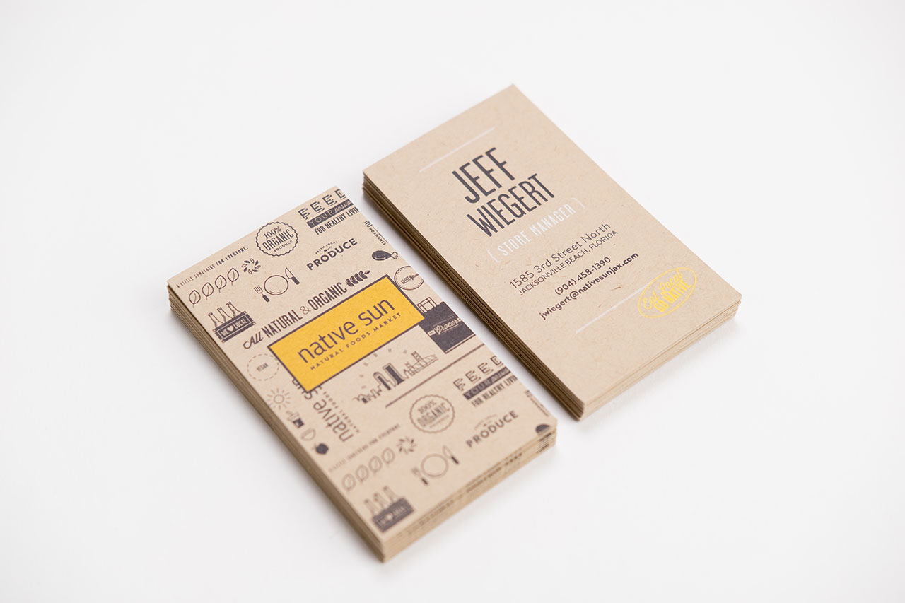 Two stacks of custom printed business cards on Kraft paper with a black and yellow design.