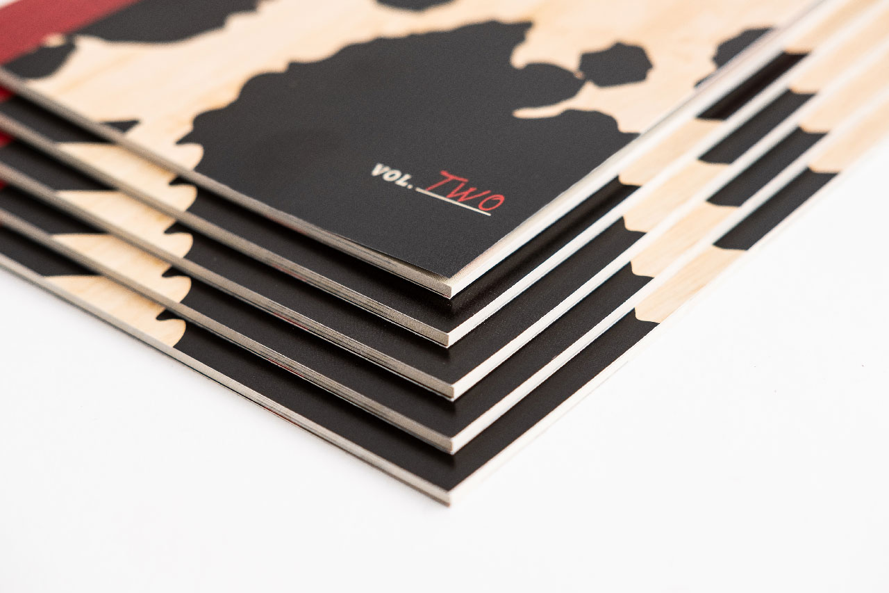 A stack of fanned-out Red Cow menus with a black, red and cream design.