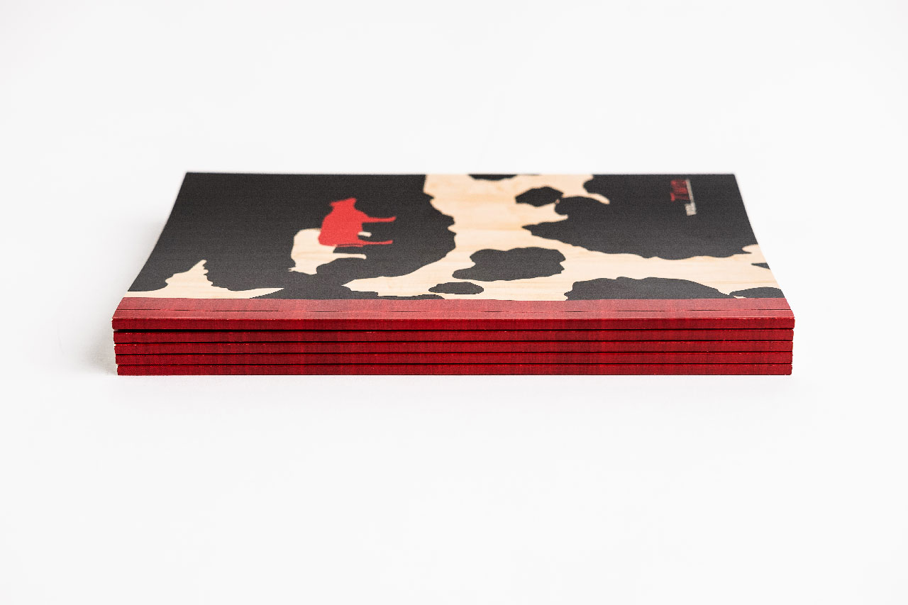 A stack of Red Cow menus with a black, red and cream design.