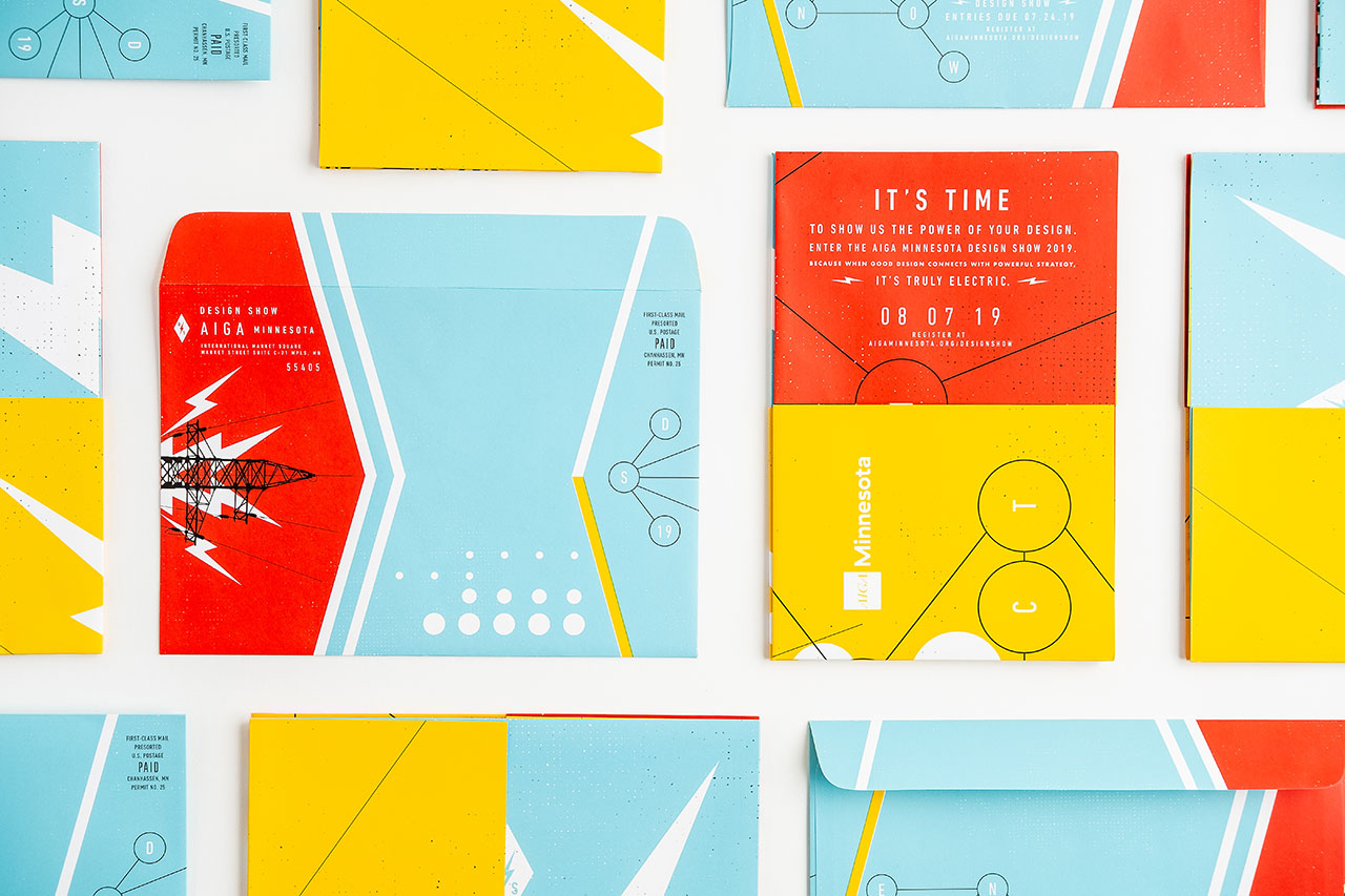 Direct mail marketing pieces lined up in rows with a bright orange, yellow and blue design.