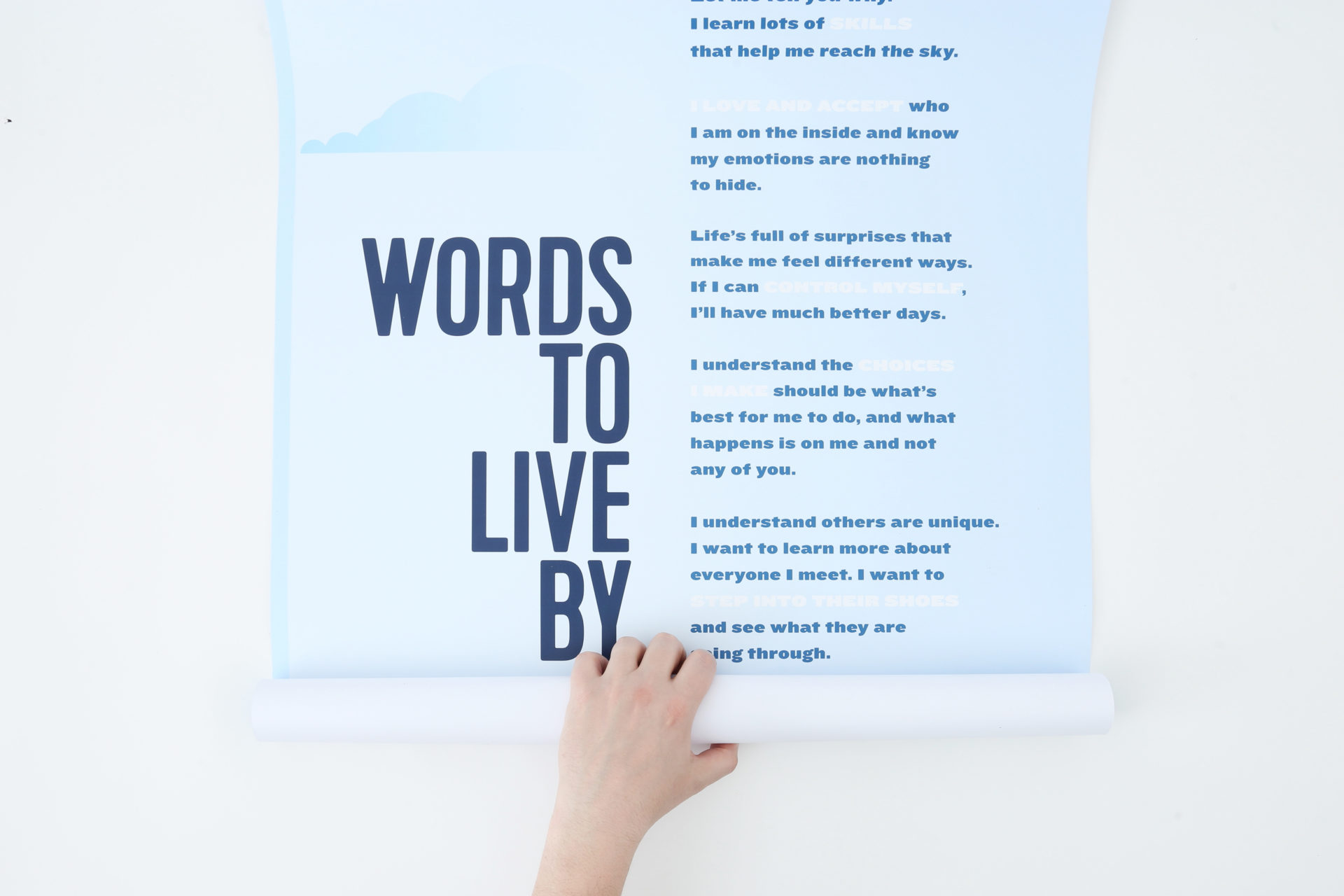 A marketing poster printed with Words to Live By and a hand unrolling the bottom.