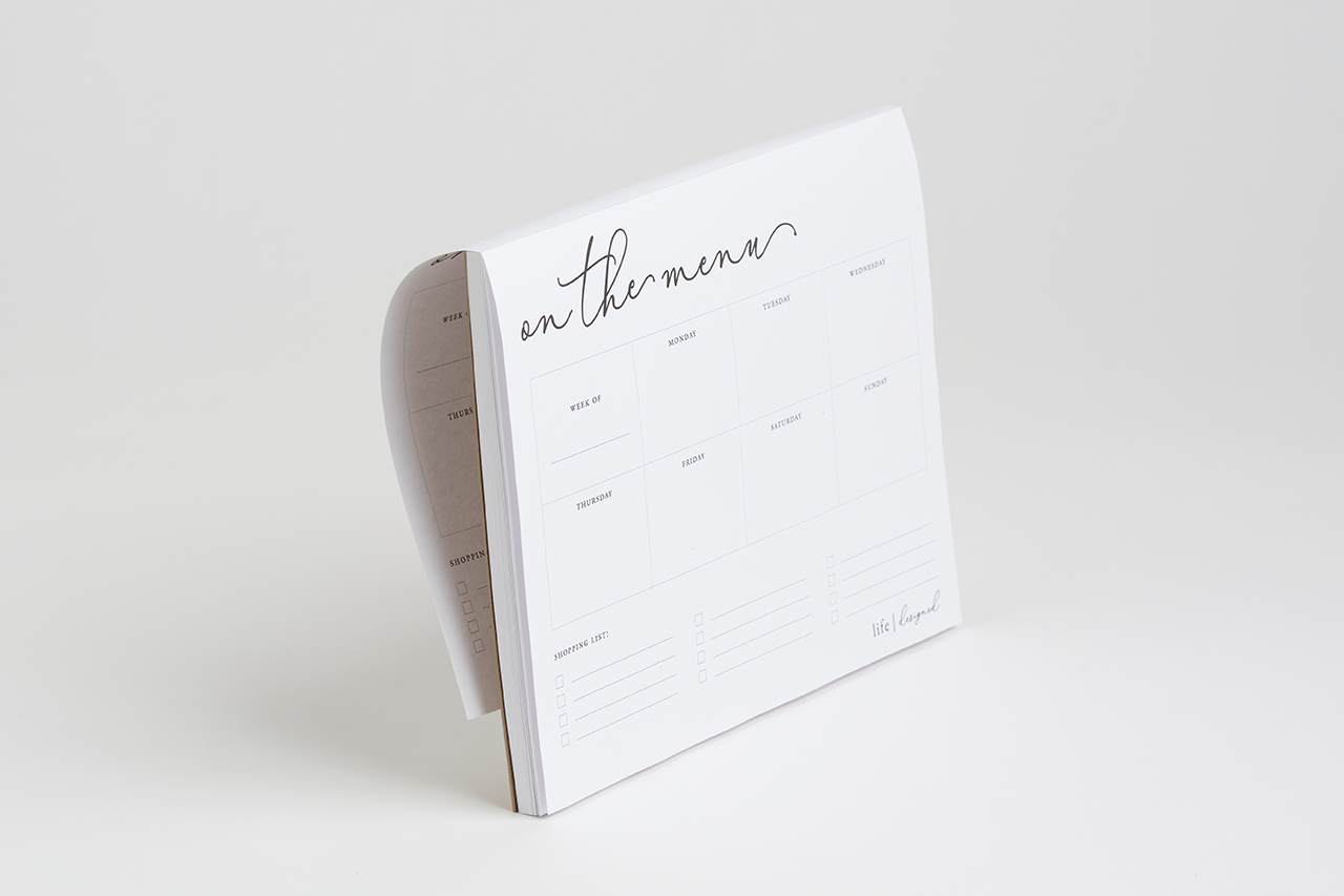 A custom notepad printed with on the menu at the top and days of the week for meal prepping.