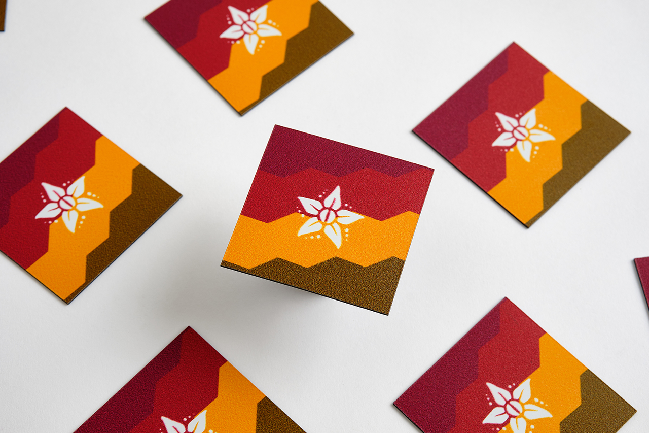 Six scattered custom magnets with a red, orange and brown design.