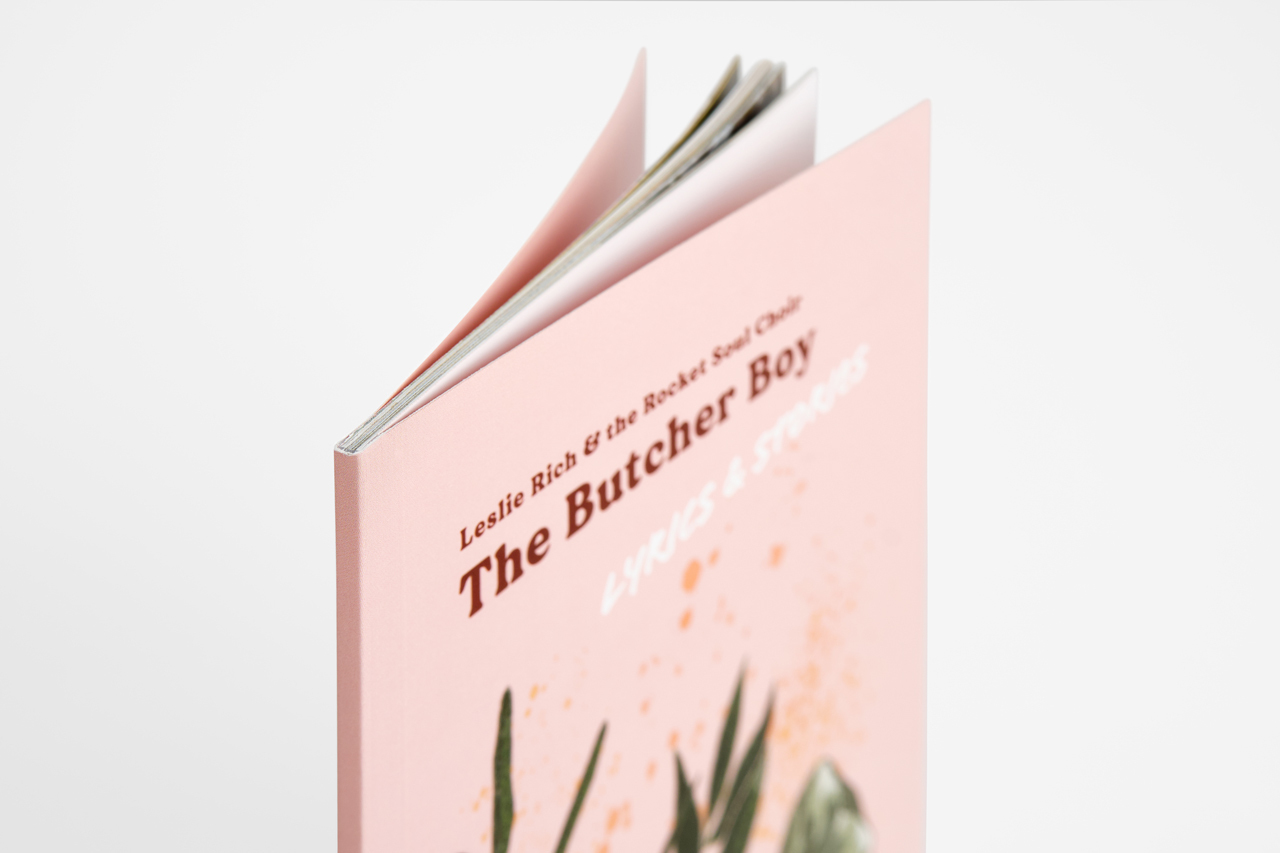A lyrics book with a perfect binding and a pink cover.