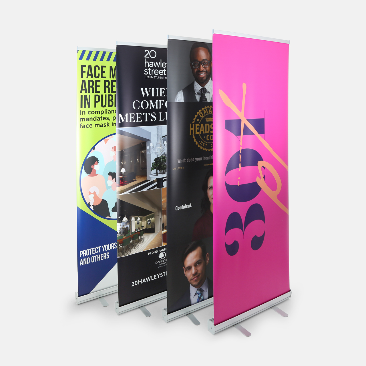 Four retractable banners printed with various marketing messages and designs.