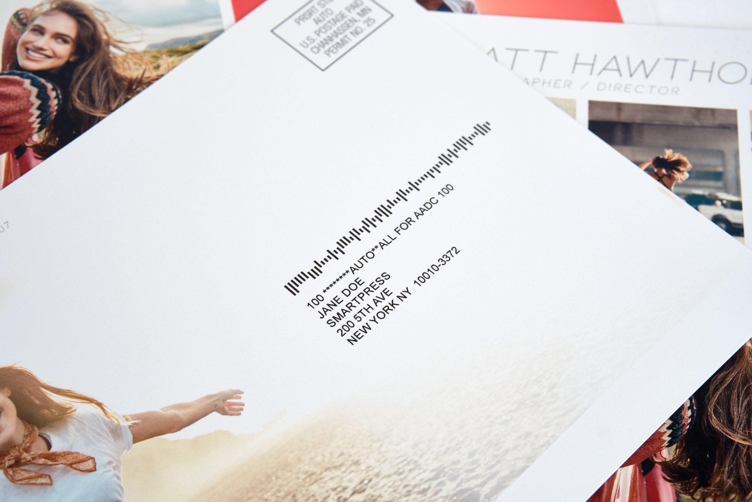 A direct mail postcard with a mailing address and mailing permit indicia in the corner.