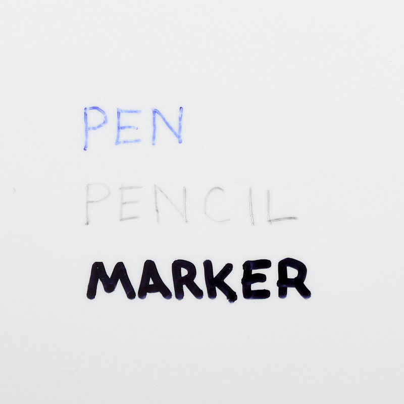 A paper stock with pen, pencil and marker written on it with each utensil.