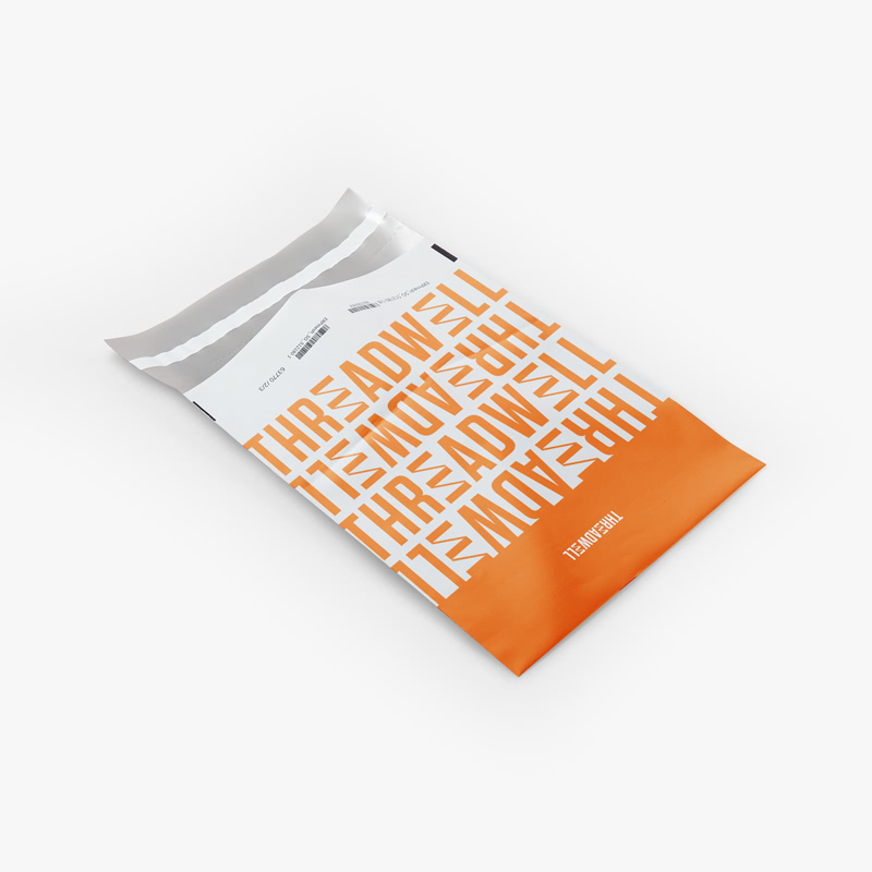 A custom poly mailer bag printed with an orange and white Threadwell design.